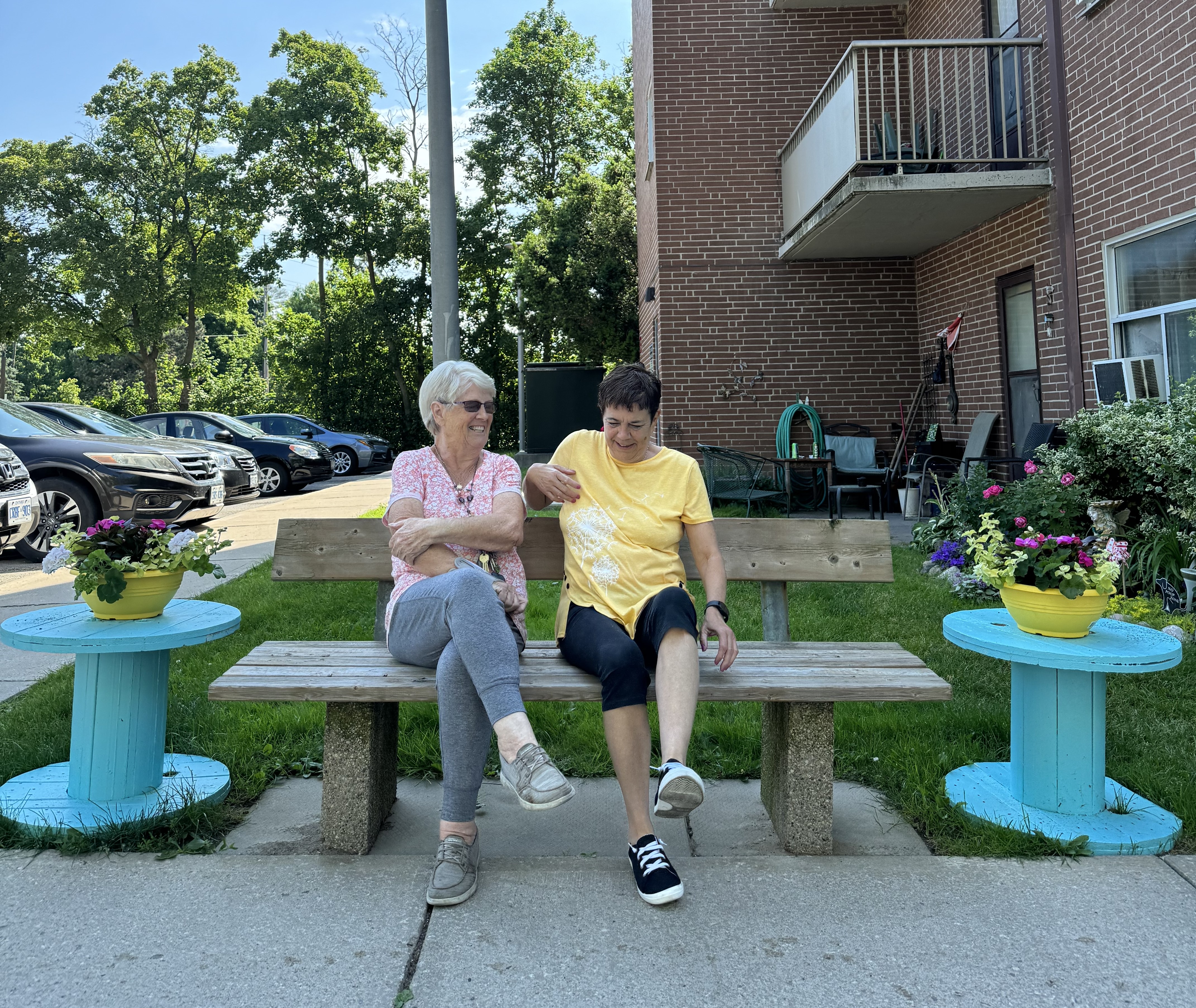 Judy and Bernadette sitting on a bench