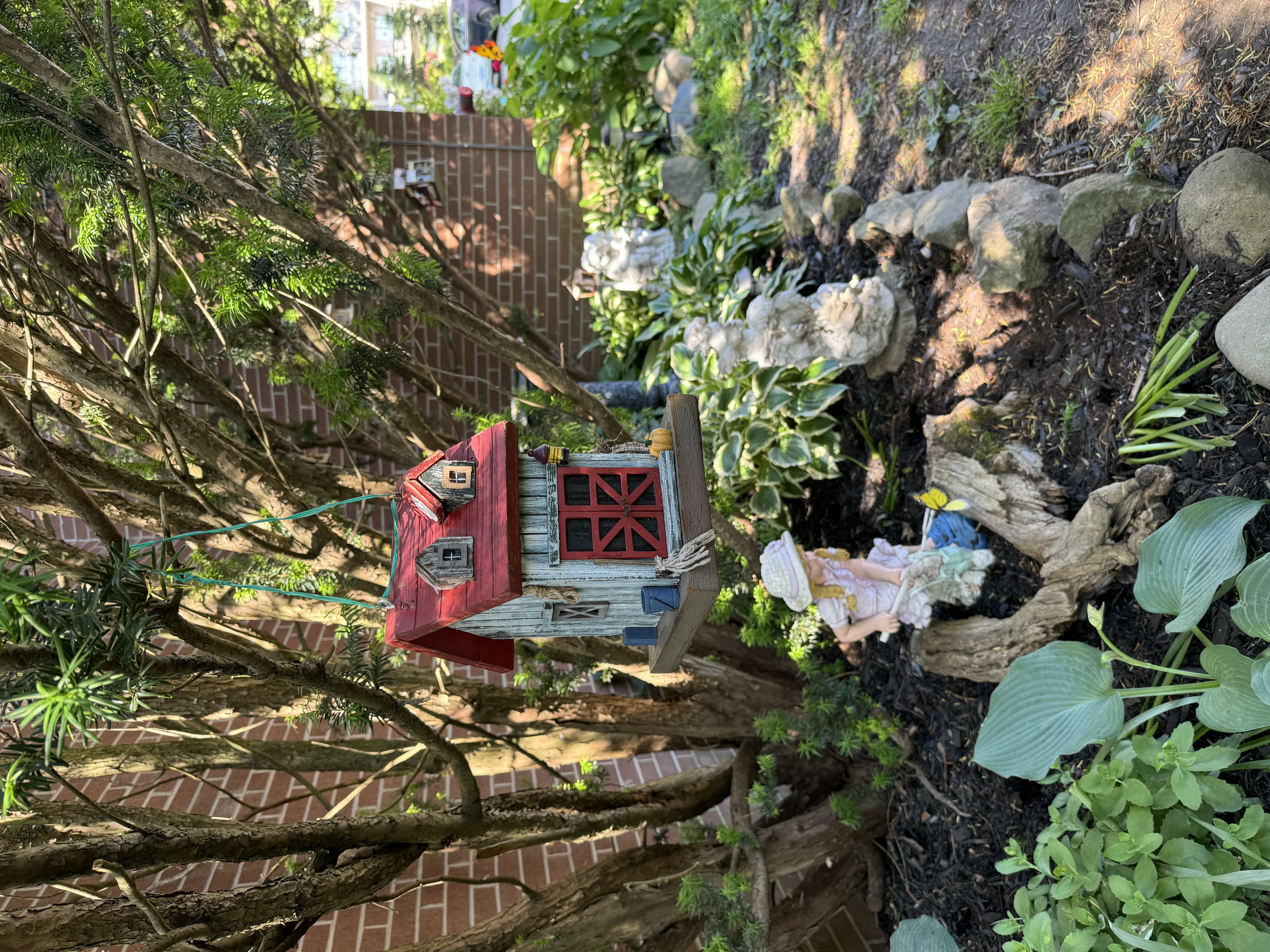 Garden with statues and birdhouse